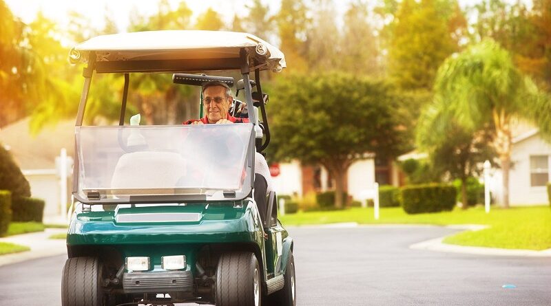 5 Perks of Golf Community Living / Man on a Golf Cart Driving Through a Golfing Community