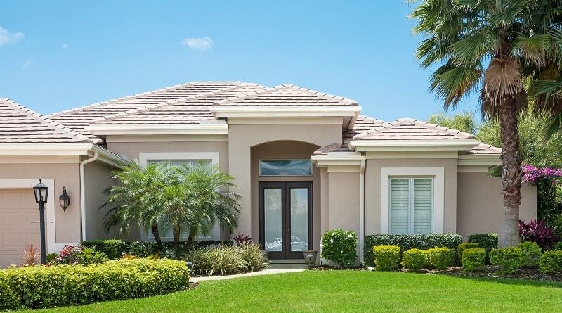 How to Choose the Right Style of Florida Window and Door for Your Home / Well landscaped home in Florida with Brown Trimmed Doors and White Trimmed Windows