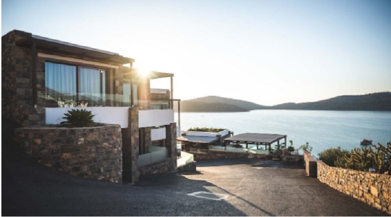 How to Maintain Your Retaining Wall for Long-Term Durability / Beautiful Home on the Water with retaining walls around the home and the large driveway
