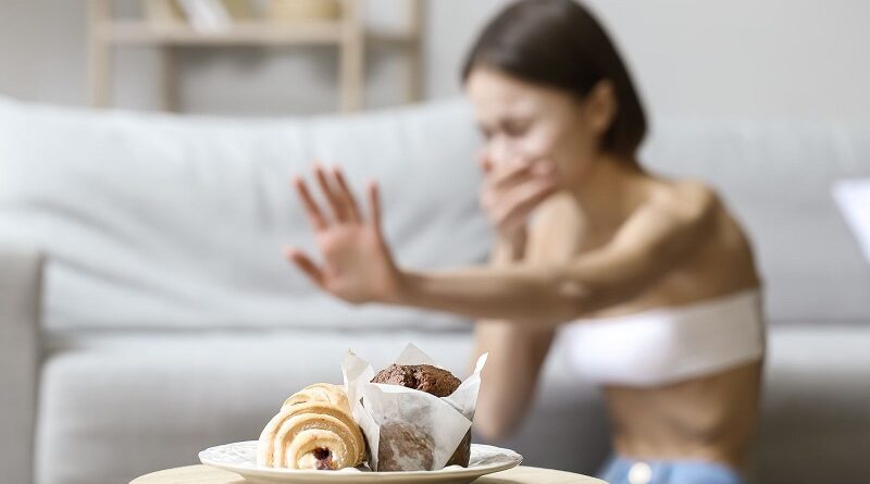 Very Thin Woman Waving Away Food / 5 Subtle Signs of an Underlying Anorexic Disorder