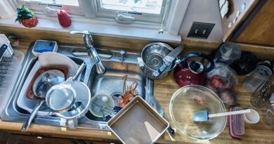 Messy Kitchen with sink filled with dirty dishes and food waste