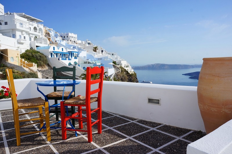 Table and chairs on deck overlooking the ocean in Greece