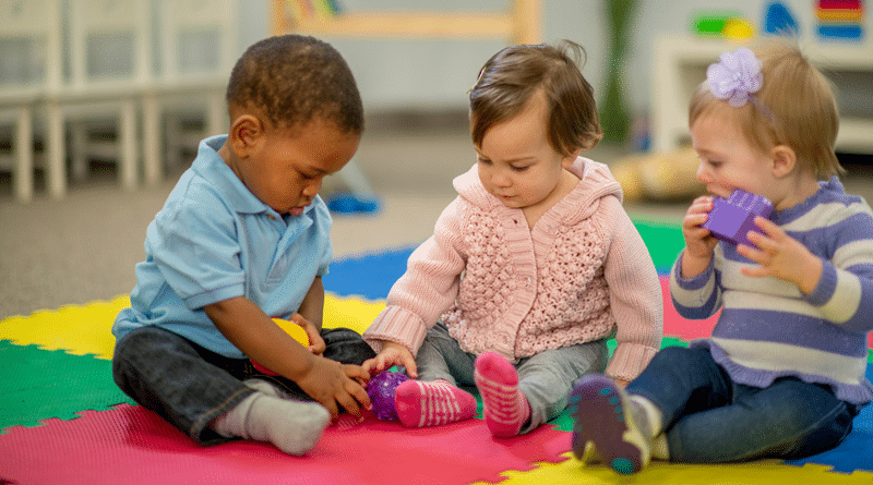 3 Toddlers Playing on a cushioned play mat / The Joys of Parenting –Tips for Toddler Care & Development