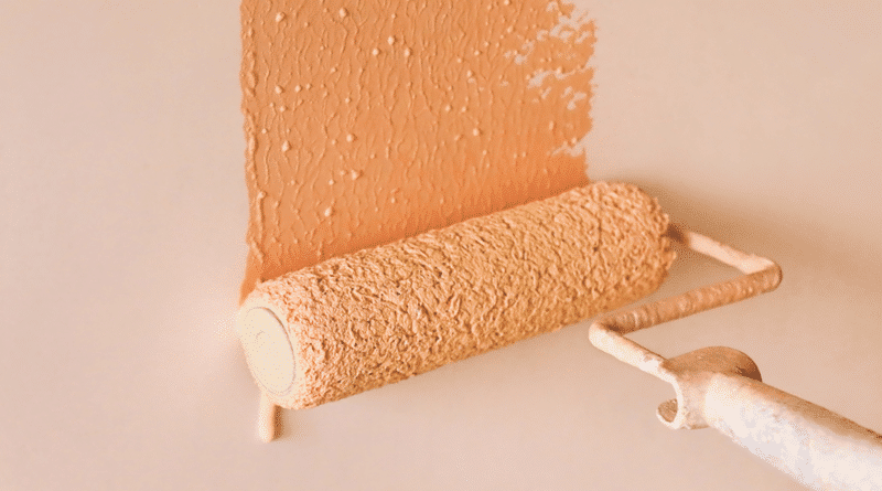 Paint Roller with Terra Cotta Color Paint on Wall