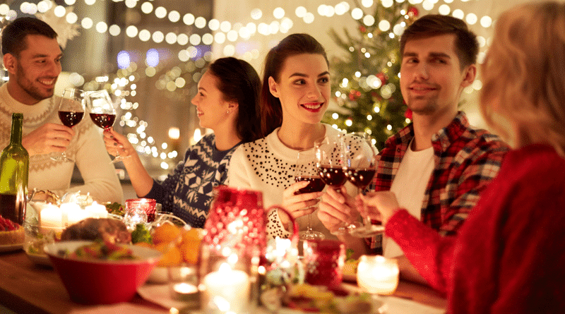 People Drinking Wine at a Table Filled with Food at a Holiday Party / Social Host Liability During Holiday Parties