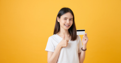 Teenage Girl with Braces Holding a Debit Card and Smiling / Empowering Kids with Financial Knowledge Through Debit Cards