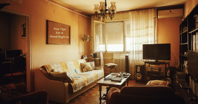 Cozy living room with a quilt on the sofa and a flat screen TV on a stand. / Five Tips For A Good Night In