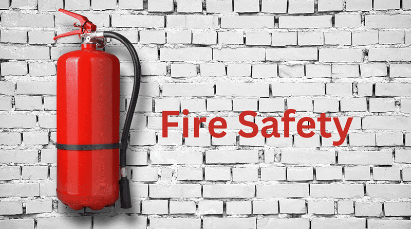 Fire Extinguisher Hanging on a White Brick Wall /