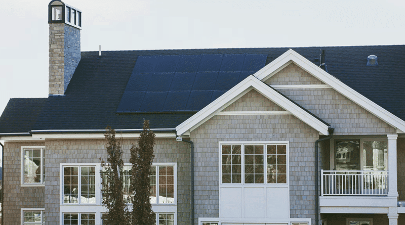Multiple Story Home with Grey Siding White Trim and Solar Panels on Roof / Eco-Friendly Ways to Make Your House Sustainable