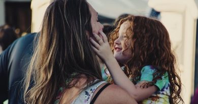 Woman holding a young girl / Ways To Keep Yourself Happy As A Busy Parent