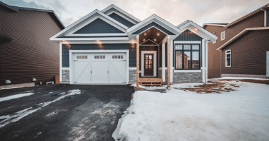 Grey and White Home with porch and under eves lighting / Front Yard Lighting: What to Pick