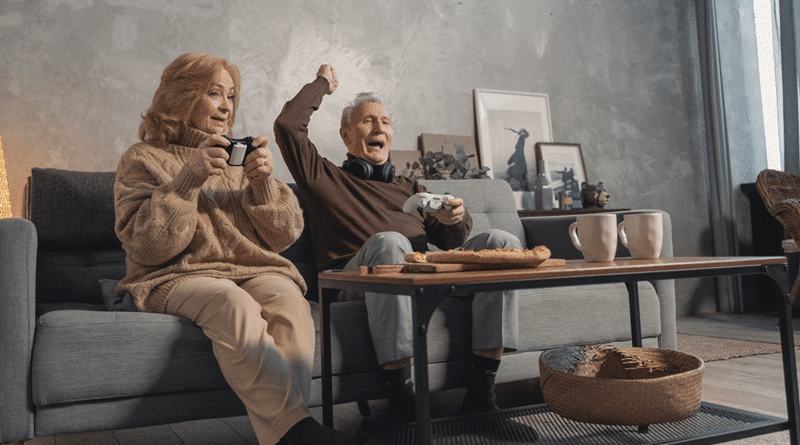 Older Couple Sitting Next to Each Other on a Sofa Playing a Video Game / Refining & Upgrading Your Home As You Get Older - Without Unsightly Additions!