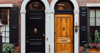 Side by Side Solid Black and Varnished Brown Door under White Stucco Arches