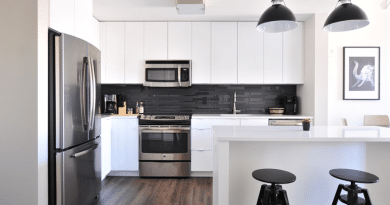 White Kitchen with Stainless Steel Appliances and Black Accents