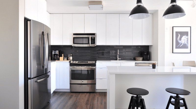 White Kitchen with Stainless Steel Appliances and Black Accents