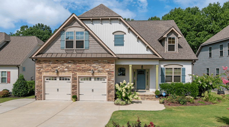 Light Brick 2 Story Home with White Siding and a Teal Trim / How to Give Your Home’s Exterior a Makeover