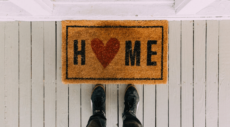 Person Standing in Front of a Homes Front Door Mat / Things That You're Going To Have To Deal With As A Homeowner