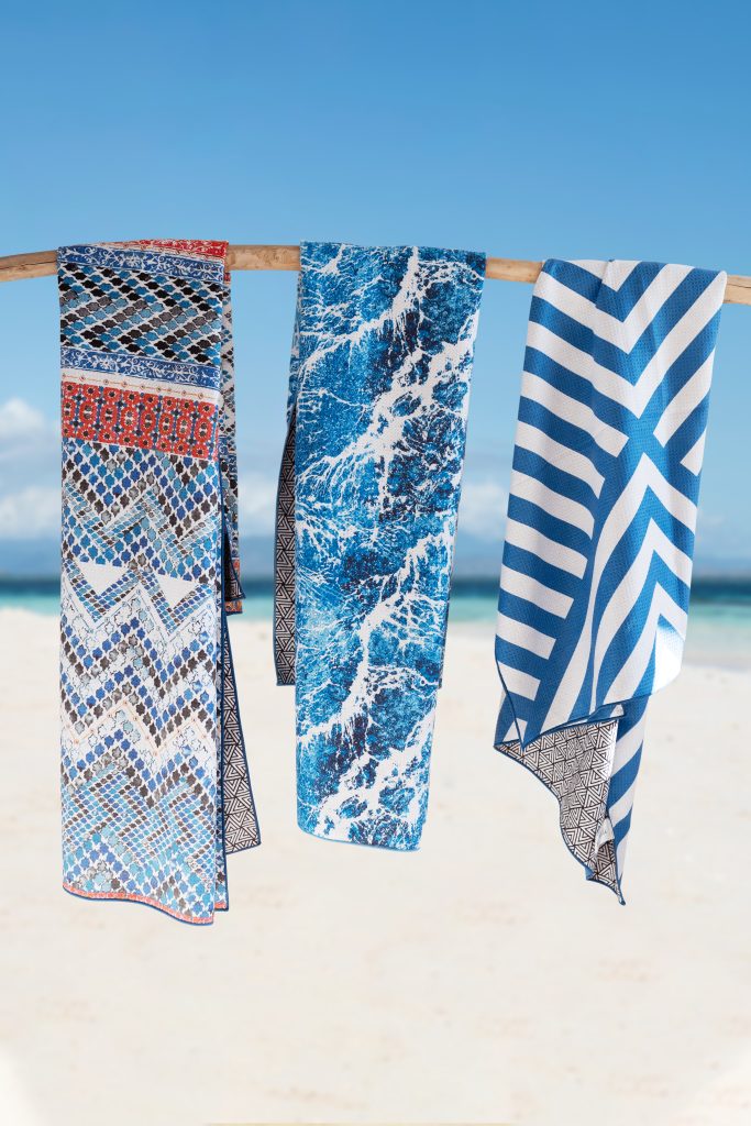 Tesalate Towels hanging from branch at the beach