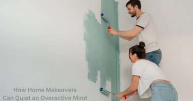 Couple wearing jeans and t-shirts painting an indoor room with rollers