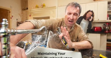 Man holding wrench with water spraying all over him from his kitchen faucet / Proactive Tips for Managing and Maintaining Your Home's Plumbing System