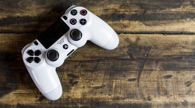 White Gaming Console on a Wooden Surface /From Virtual Clutter to Real-Life Junk: How Gamers Can Keep Their Spaces Clean